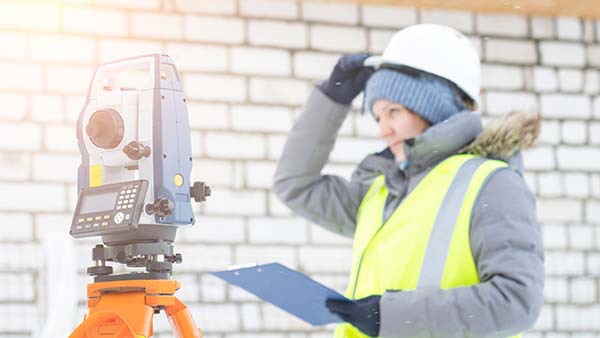 A woman in a safety vest conducting a noise survey